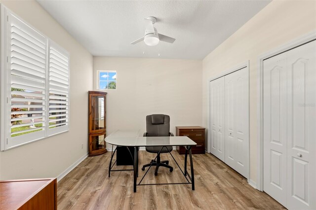 office space with light wood-type flooring and ceiling fan