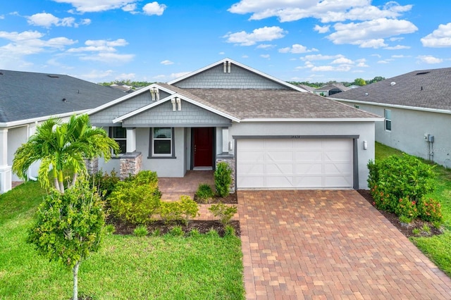 view of front of home featuring a front yard and a garage