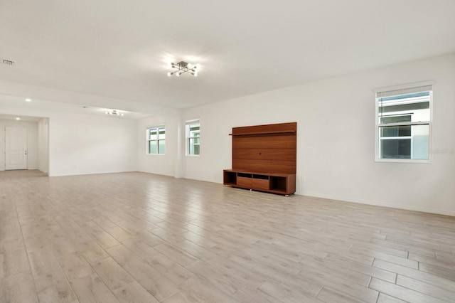 unfurnished room with light wood-type flooring