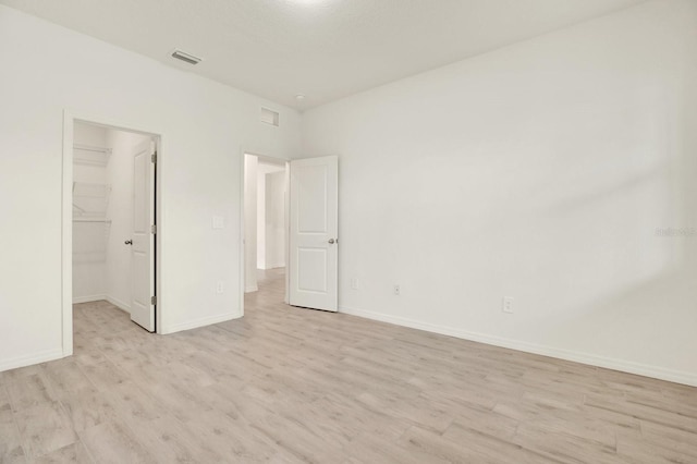 spare room featuring light wood-type flooring