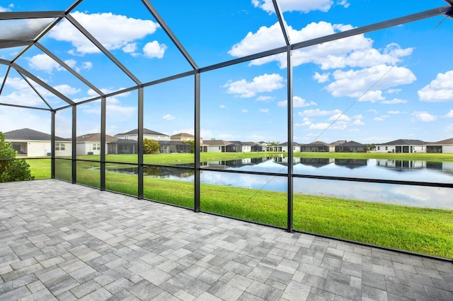 unfurnished sunroom featuring a water view