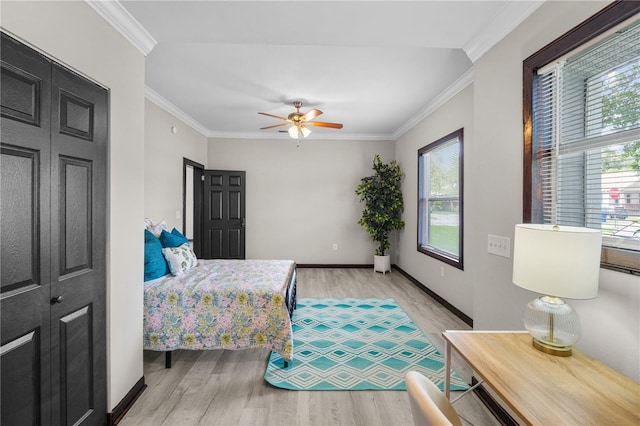 bedroom with ceiling fan, light hardwood / wood-style floors, and ornamental molding