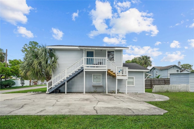 rear view of property with a yard