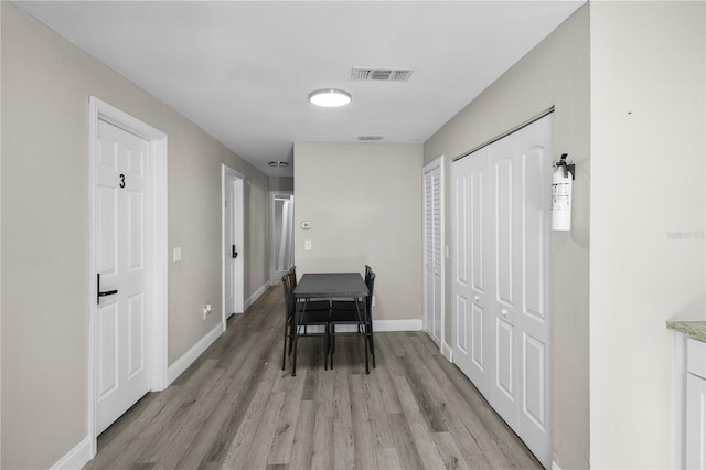 corridor with light hardwood / wood-style flooring