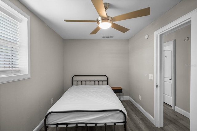 bedroom featuring ceiling fan and dark hardwood / wood-style floors