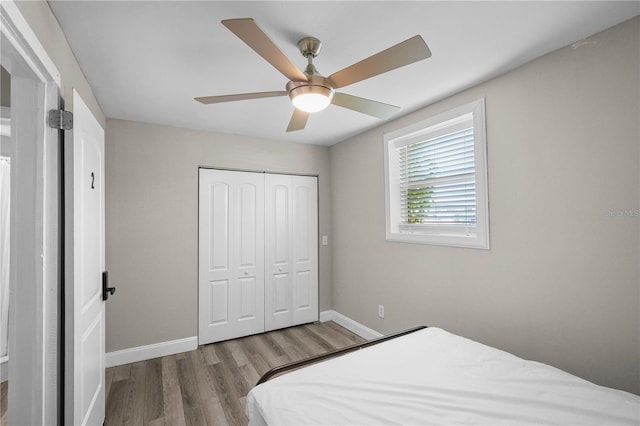 bedroom featuring ceiling fan, a closet, and light hardwood / wood-style floors