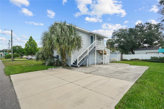 view of side of home with a yard