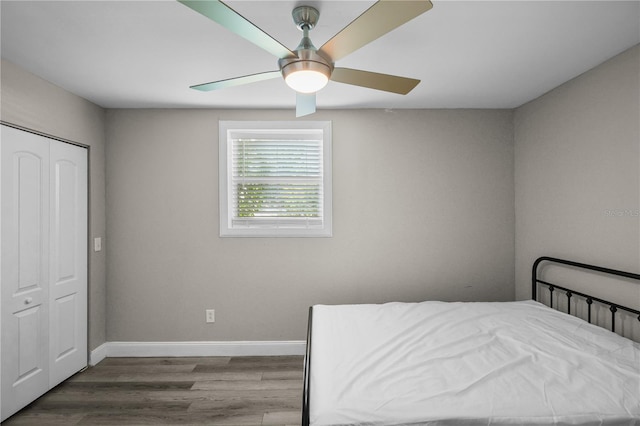 bedroom featuring ceiling fan, a closet, and hardwood / wood-style flooring