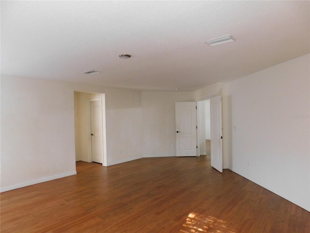 spare room featuring dark wood-type flooring