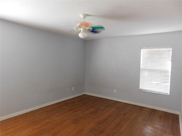 unfurnished room featuring a textured ceiling and dark wood-type flooring