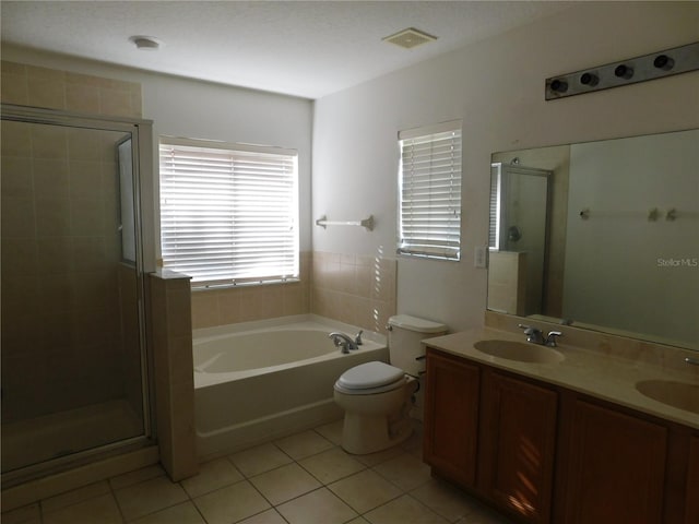 full bathroom featuring tile patterned floors, independent shower and bath, vanity, and toilet