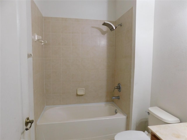 full bathroom with tiled shower / bath combo, vanity, and toilet