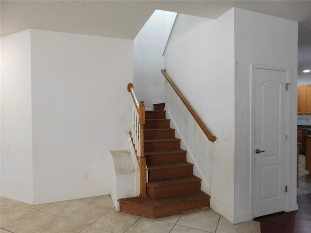 stairs featuring tile patterned flooring