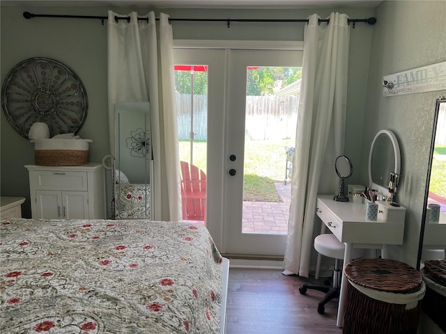 bedroom with access to exterior, french doors, and hardwood / wood-style flooring