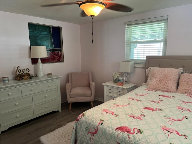 bedroom with dark hardwood / wood-style flooring and ceiling fan