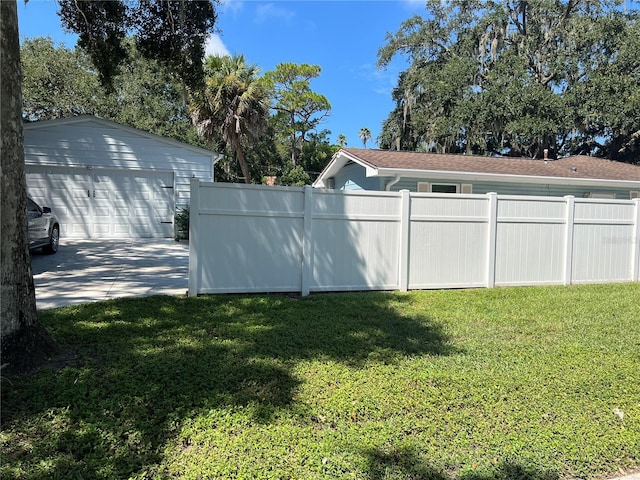 view of yard featuring a garage and an outbuilding