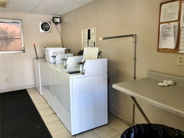 washroom with washer and clothes dryer and light tile patterned flooring