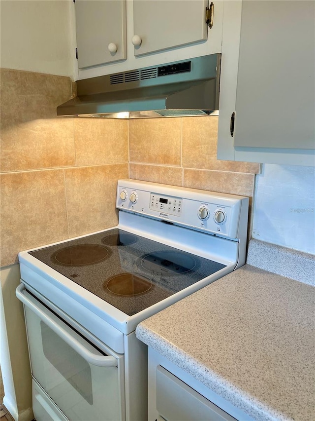 room details with backsplash and white electric stove