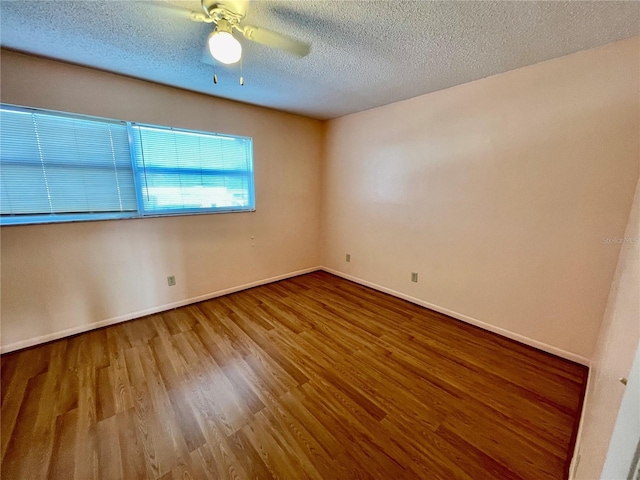 spare room with hardwood / wood-style floors, ceiling fan, and a textured ceiling