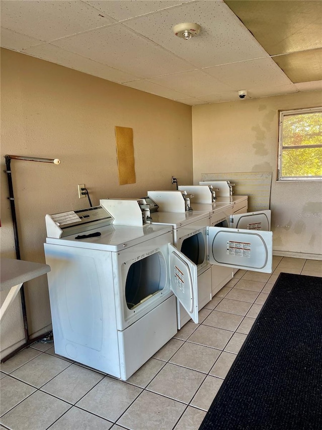 laundry area featuring washing machine and dryer and light tile patterned floors