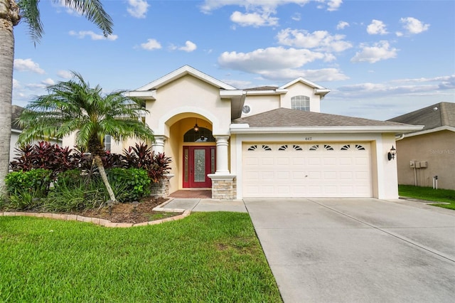 view of front facade with a front yard and a garage