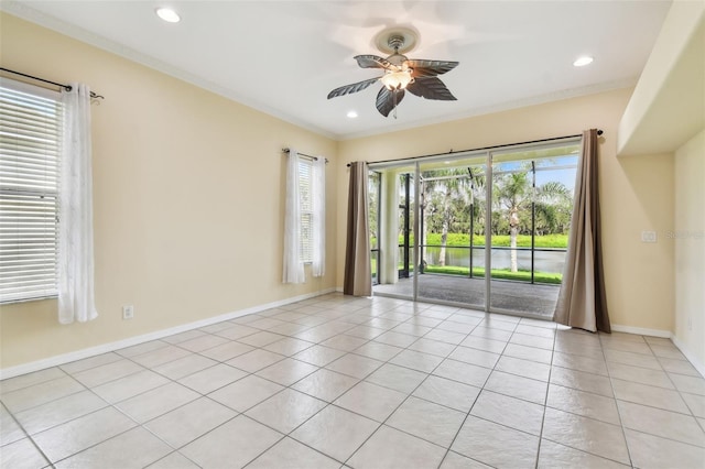 spare room featuring ceiling fan, light tile patterned flooring, and crown molding