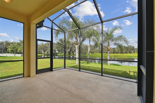 unfurnished sunroom with a water view