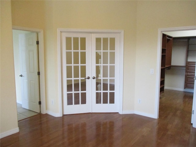 unfurnished room featuring french doors and hardwood / wood-style floors