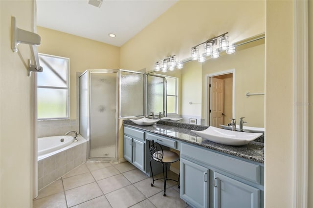 bathroom featuring plus walk in shower, vanity, and tile patterned floors