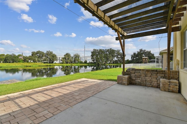 view of patio / terrace featuring a pergola and a water view