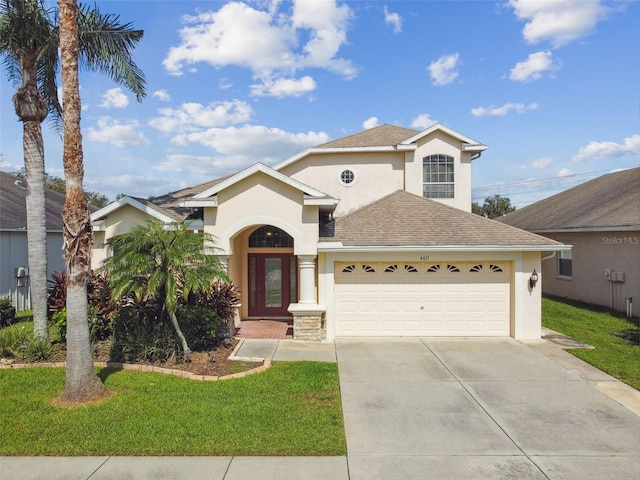 view of front of house with a front yard and a garage