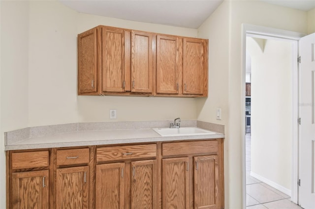 kitchen featuring sink and light tile patterned floors