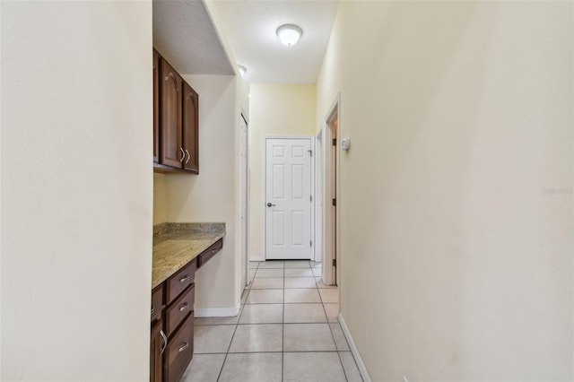 corridor with light tile patterned flooring