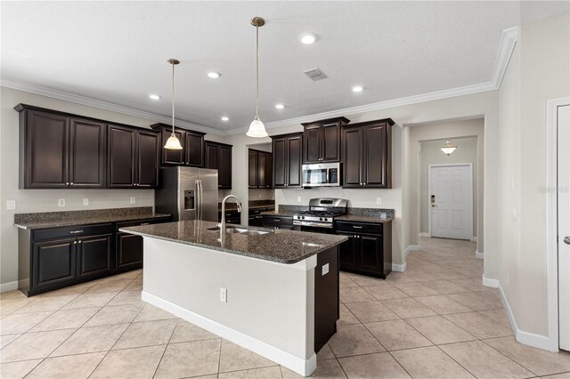 kitchen with decorative light fixtures, stainless steel appliances, sink, light tile patterned floors, and a center island with sink