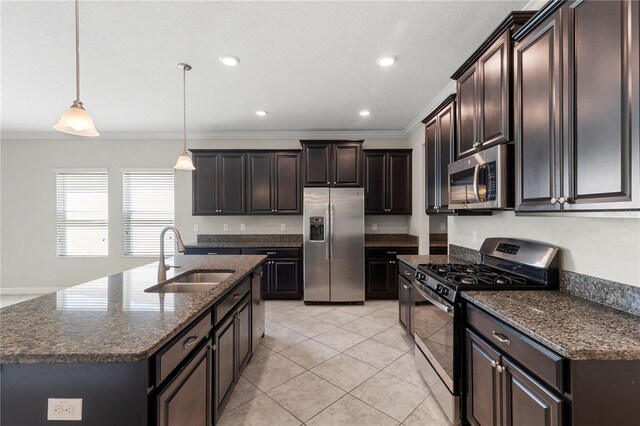 kitchen with dark stone countertops, sink, crown molding, hanging light fixtures, and appliances with stainless steel finishes