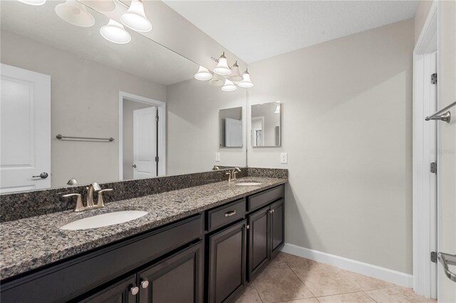 bathroom with tile patterned floors and vanity