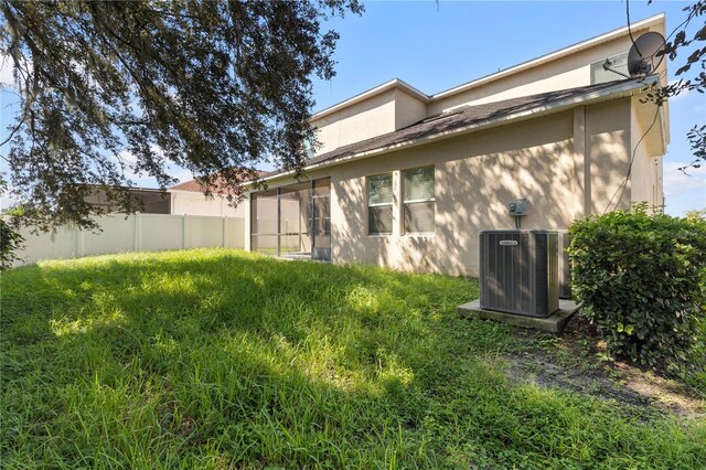 rear view of property featuring central AC unit