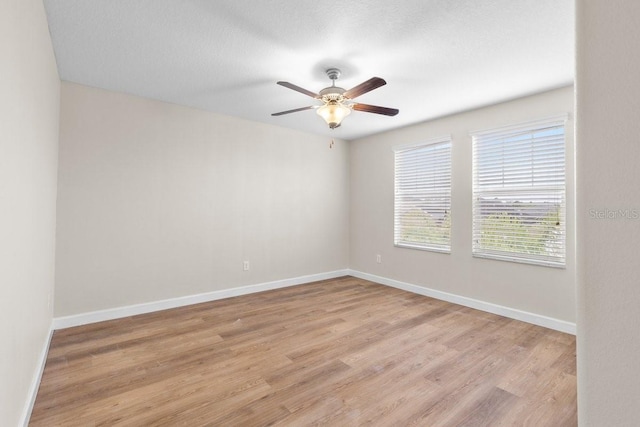 empty room featuring ceiling fan and light hardwood / wood-style floors