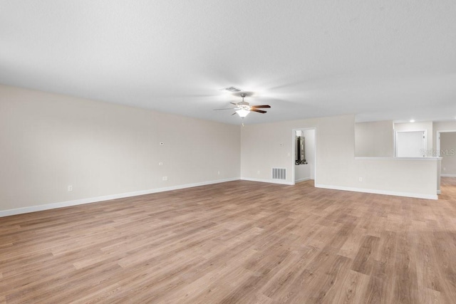 unfurnished living room featuring ceiling fan and light hardwood / wood-style floors