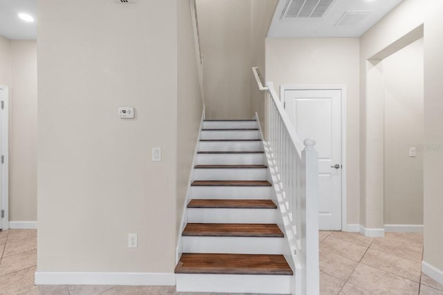 stairway with tile patterned flooring