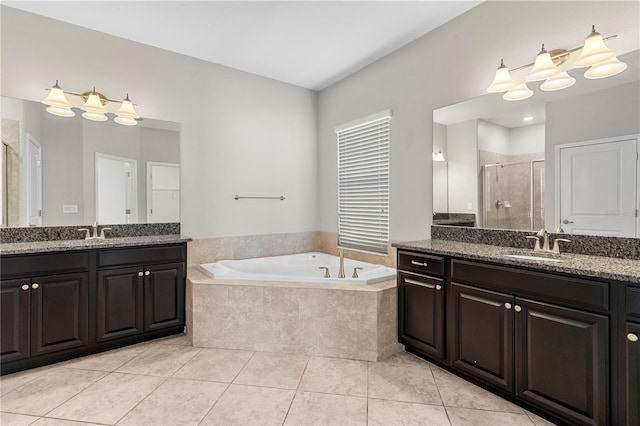 bathroom featuring tile patterned flooring, separate shower and tub, and vanity