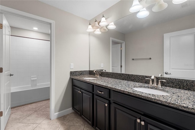 bathroom featuring washtub / shower combination, tile patterned floors, and vanity