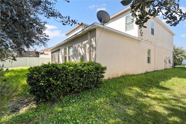 view of side of property with a yard