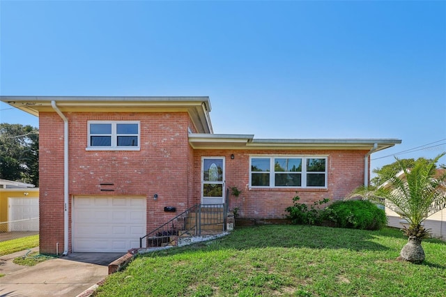 split level home with a garage and a front lawn