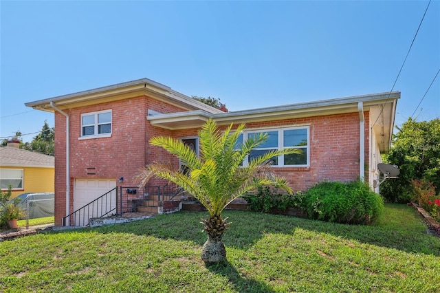 view of front of home featuring a front yard and a garage