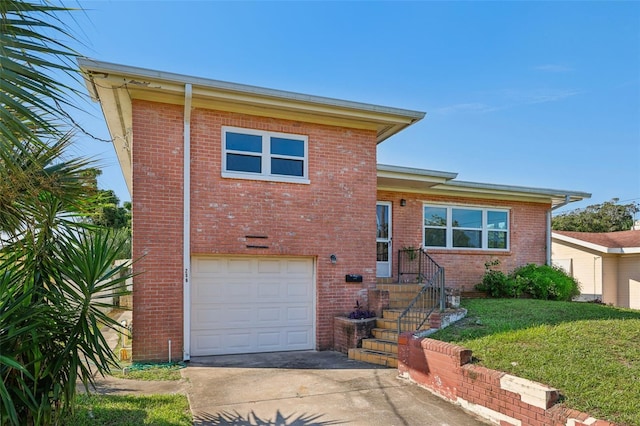 tri-level home with a garage and a front yard