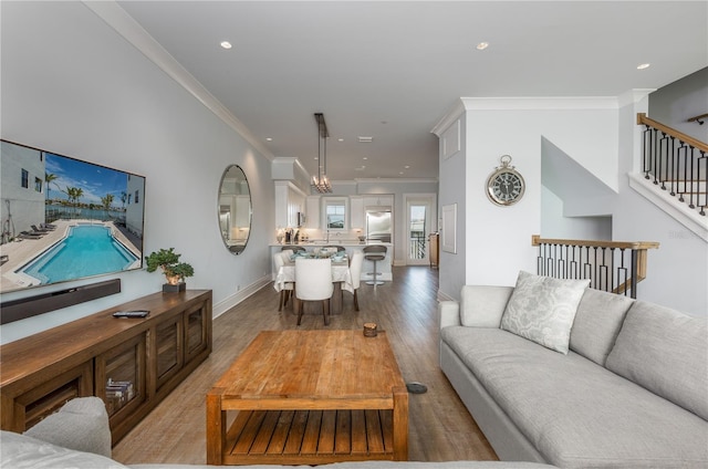 living room with ornamental molding and hardwood / wood-style floors