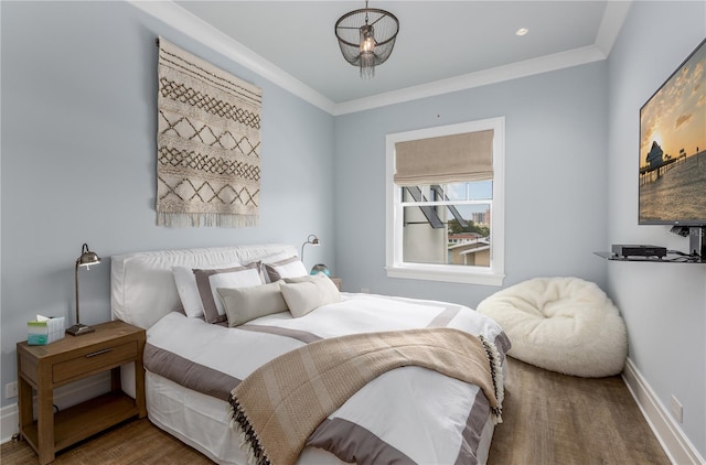 bedroom featuring wood-type flooring and ornamental molding