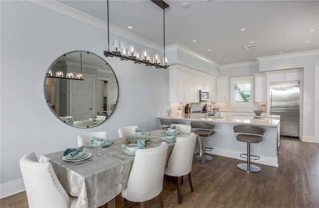 dining room with ornamental molding, dark wood-type flooring, and a chandelier