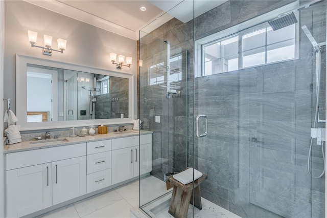 bathroom with a shower with shower door and vanity